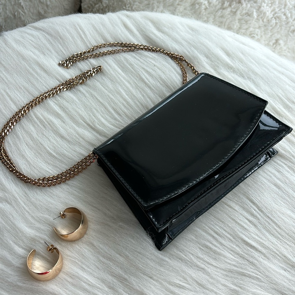 Black patent leather bag with gold hardware